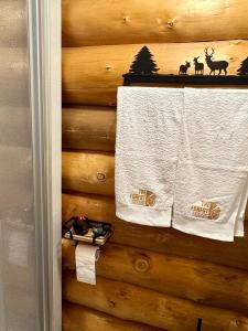 a towel is hanging on a wooden wall at The Forest House in La Comballaz +10 photos
