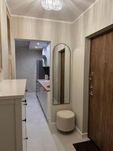 a bathroom with a mirror and a toilet in it at Lake View Apartment in Telšiai +15 photos