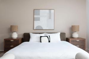 a bedroom with a large white bed with two night stands at Boardwalk Hotel On Lake Anna By Kasa in Mineral