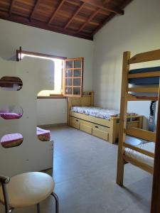 a bedroom with a bunk bed and a ladder at Chácara Recanto Colibri in Socorro +20 photos