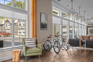 a living room with two bikes parked in a room with windows at The Vic By Kasa in Traverse City