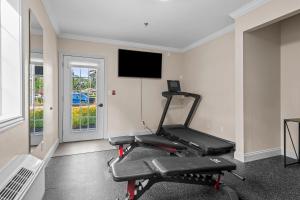 a gym with a treadmill and a flat screen tv at The Vic By Kasa in Traverse City