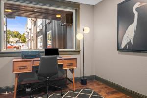 an office with a desk with a computer and a window at The Vic By Kasa in Traverse City