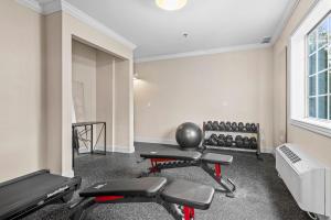 an empty gym with two chairs and weights at The Vic By Kasa in Traverse City +3 photos