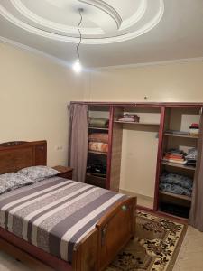a bedroom with a bed and a white ceiling at Chez ZAKi in Meknès