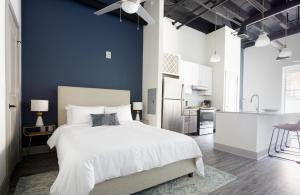 a bedroom with a white bed and a blue wall at Kasa Altmayer Savannah in Savannah +32 photos