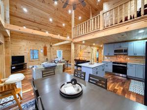 a kitchen and living room of a log cabin at 2S New log cabin in Bethlehem - privacy, firepit, great location! in Bethlehem