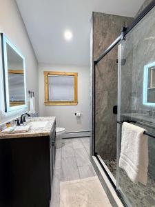 a bathroom with a shower and a sink at 2S New log cabin in Bethlehem - privacy, firepit, great location! in Bethlehem