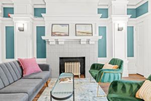 a living room with a couch and chairs and a fireplace at Kasa La Monarca San Francisco in San Francisco