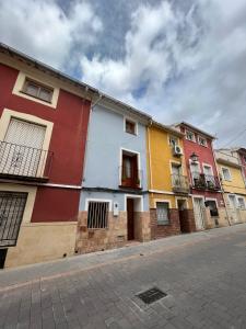 a row of colorful houses on a street at Halona Casa Rural in Bullas