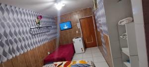 a small room with a small bed and a small bathroom at Pousada Zélia Barros in Natal +211 photos