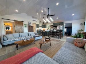 a living room with a couch and a table at 2T Bethlehem Retreat with Stunning Sunset Views in the Heart of the White Mountains in Bethlehem