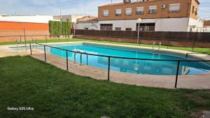 an empty swimming pool in the middle of a yard at Luxury A Huertas 143 in Tomelloso
