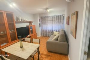 a living room with a couch and a table at Luxury A Huertas 143 in Tomelloso