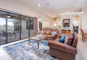a living room with two couches and a table at Surfside in Cape Coral