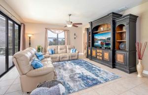 a living room with a couch and a large entertainment center at Surfside in Cape Coral