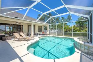 an indoor swimming pool with a glass roof at Surfside in Cape Coral