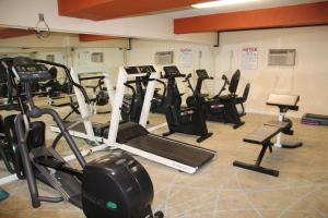 a gym with a bunch of exercise bikes and treadmills at Bedford Plaza Hotel - Boston in Bedford
