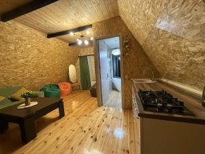 a kitchen with a stove and a counter top at Altimo კოტეჯი ალტიმო in Norio +7 photos