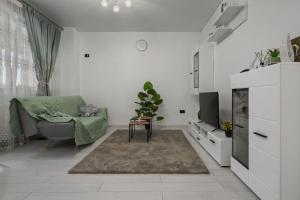 a living room with a couch and a tv at Apartament Militari Residence in Dudu +22 photos