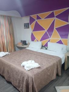 a hotel room with two beds with towels on the bed at Hotel Florencia in Mexico City
