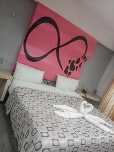 a bedroom with a bed with a painting on the wall at Hotel Florencia in Mexico City +4 photos