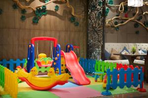 a childrens play area with a slide and a playground at Wanda Realm Jingzhou in Jingzhou