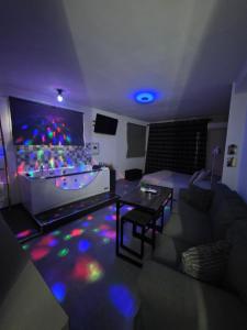 a living room with a couch and a table at El nido de la Galería in Setenil