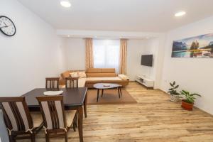 a living room with a table and a couch at Apartment Center in Kolašin