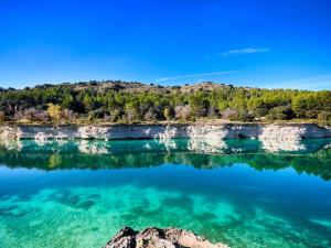 a view of the water of a lake with trees at Luxury Monte 65 in Tomelloso