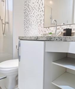 un bagno bianco con lavandino e WC di Brisa do Mar - Varanda/2 qtos/Est/Ar a Campo Grande Altre 54 foto
