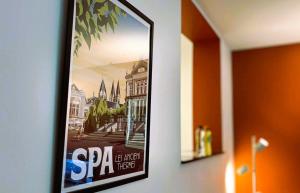 a framed picture of a city on a wall at Au Petit Pierrot in Spa