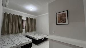 En eller flere senge i et værelse på Casa Recanto Ville