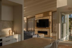 a living room with a television and a fireplace at Oceano House in Copacabana +35 photos