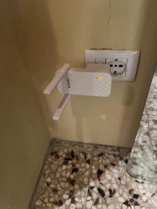 a bathroom with a sink with a knife on the wall at fienile di frida in Lucca