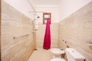 a bathroom with a toilet and a sink at Villa Tanzanite Hikkaduwa in Hikkaduwa
