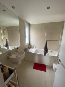 a bathroom with a tub and a sink and a toilet at Stunning Villa 25' from Barcelona in Las Canteras