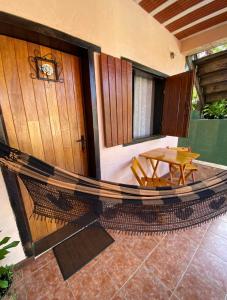 a porch with a hammock and a table on a house at Pousada Maruru in Serra do Cipo +70 photos