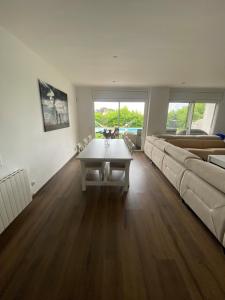 a living room with a couch and a table at Stunning Villa 25' from Barcelona in Las Canteras +42 photos