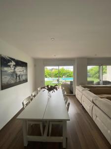 a living room with a table and a couch at Stunning Villa 25' from Barcelona in Las Canteras