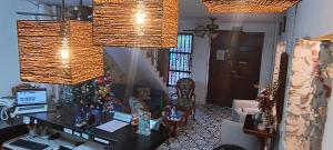 a living room with a desk and a christmas tree at Hostal Casa de las Americas in Cartagena de Indias
