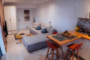 a living room with a couch and a table at la Canne a sucre in Pointe-Noire