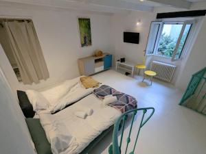 a small room with a bed and chairs in it at Casa colore intera casa nel borgo antico in Ossuccio