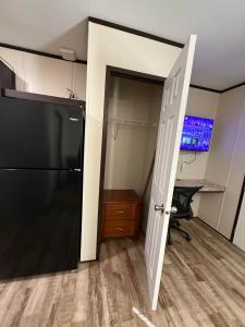 an open door to a kitchen with a refrigerator at Mesquite Oasis Lodging in Odessa