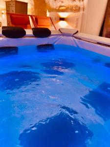 a pool with blue water in a room at Exceptional Apartment Île Saint Louis - Jacuzzi in Paris