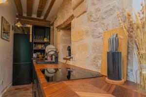 a kitchen with a counter and a stone wall at Exceptional Apartment Île Saint Louis - Jacuzzi in Paris