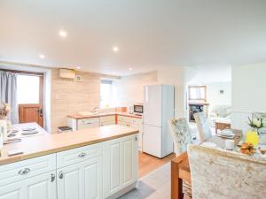 a kitchen with white cabinets and a white refrigerator at 3 Bed in Newton-on-Rawcliffe 88958 in Newton