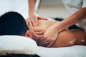 a man getting a massage from a therapist at NG Trips in Hurghada
