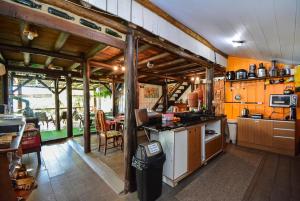 a kitchen with a stove and a counter top at Hostel do Morro in Florianópolis +58 photos