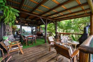 a wooden deck with chairs and tables on it at Hostel do Morro in Florianópolis